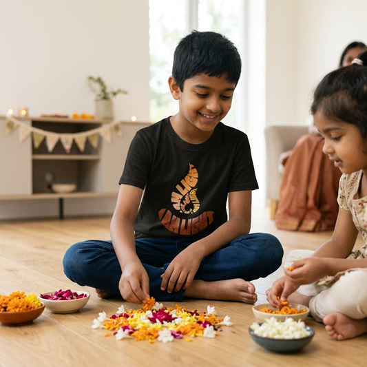 Child wearing an I Am Light youth T-shirt while making a flower-petal rangoli for Diwali