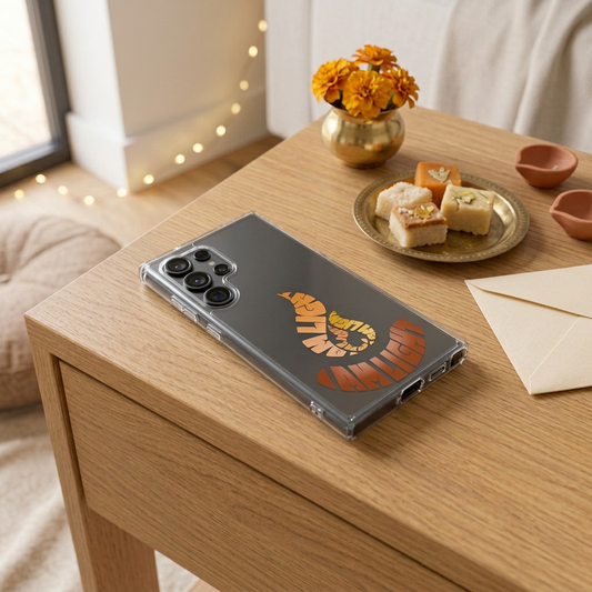 I Am Light clear Samsung case lying flat on an oak table with understated Diwali decorations and sweets